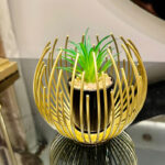 Metallic golden globe decor with planter inside